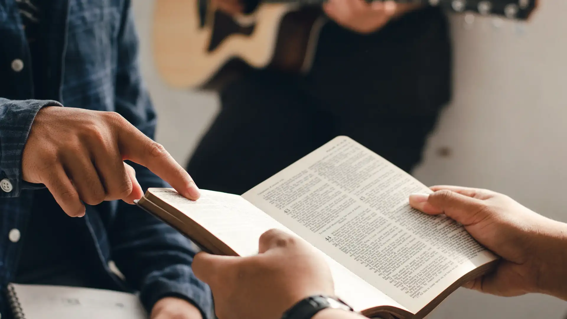 Finger pointing at a bible